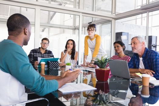 Business people discussing at desk during meeting in office