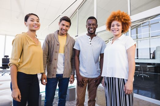 Portrait of cheerful business people standing in office