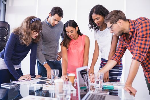 Business people discussing at desk in office