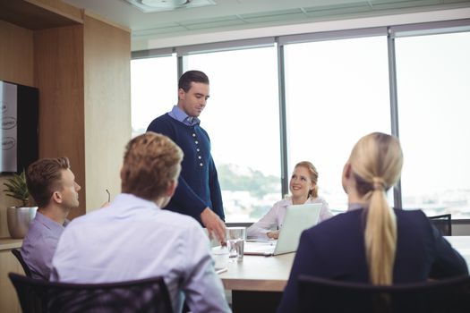 Business people discussing during meeting in board room