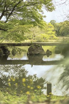 japanese Togetsu Stone bridge on the pond of Rikugien Park in Bunkyo district, north of Tokyo. The park was created at the beginning of the 18th century.