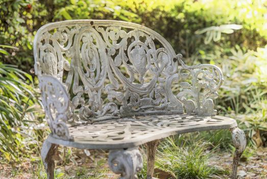 White cast iron bench in the garden of Asukayama park in the Kita district of Tokyo, Japan.