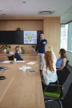 Business people discussing at conference table in board room