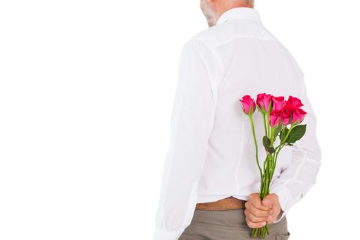 Man holding bouquet of roses behind back on white background