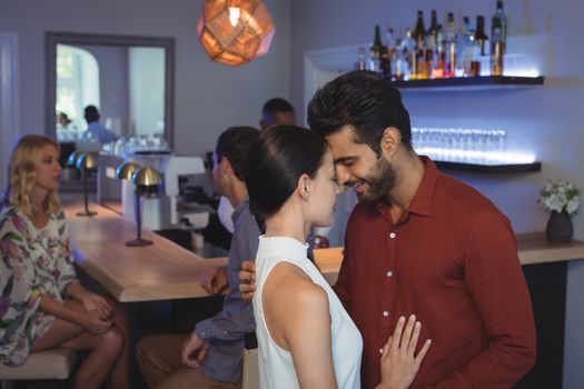 Romantic couple embracing each other at bar restaurant