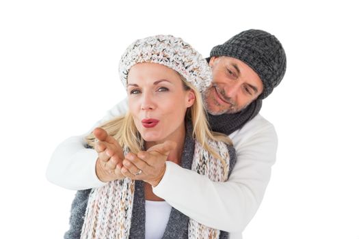 Smiling couple in winter fashion posing on white background