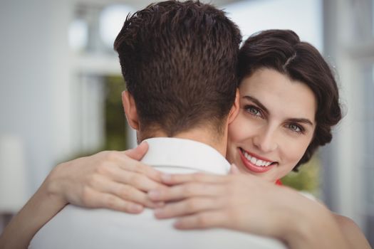 Romantic couple embracing each other in restaurant