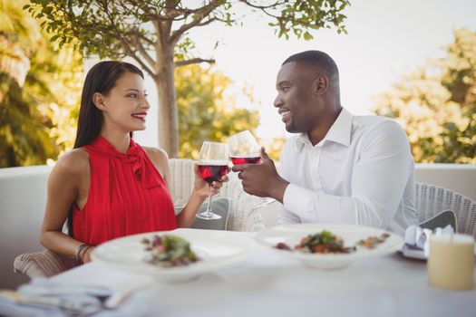 Romantic couple toasting their wine glasses in restaurant