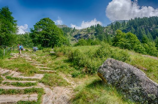 Hiking for health in Italian alps landscape