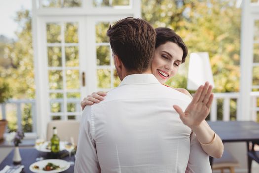 Romantic couple embracing each other in restaurant