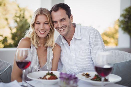 Portrait of romantic couple sitting together in restaurant