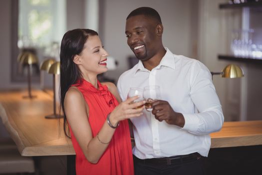 Romantic couple toasting wine glasses in restaurant