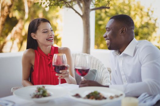 Romantic couple toasting their wine glasses in restaurant