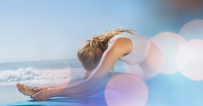 Digital composite of Young woman performing yoga at beach