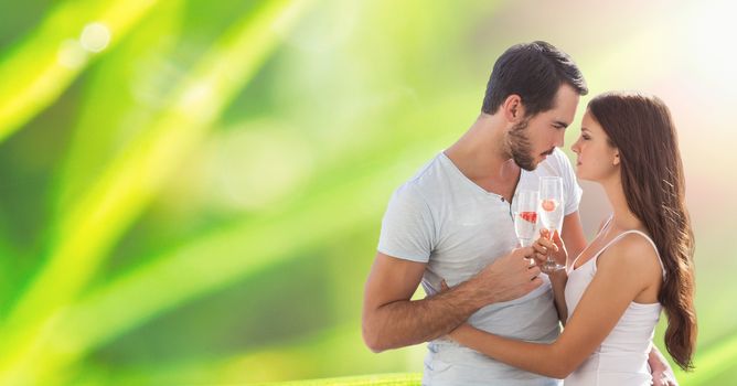 Digital composite of Loving couple holding champagne flutes outdoors