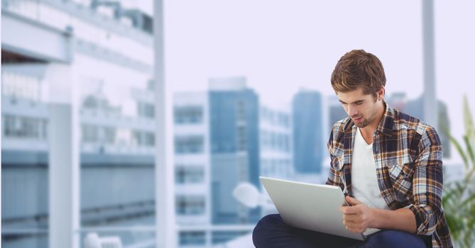 Digital composite of Businessman using laptop outdoors