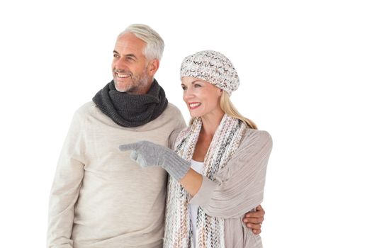 Happy couple in winter fashion looking on white background