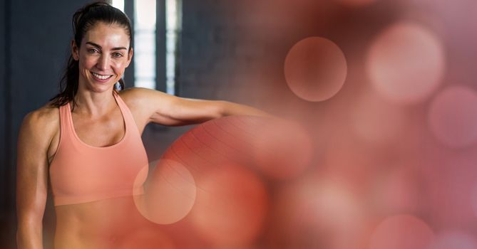 Digital composite of Woman with yoga ball and red bokeh transition