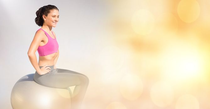 Digital composite of Smiling woman sitting on yoga ball