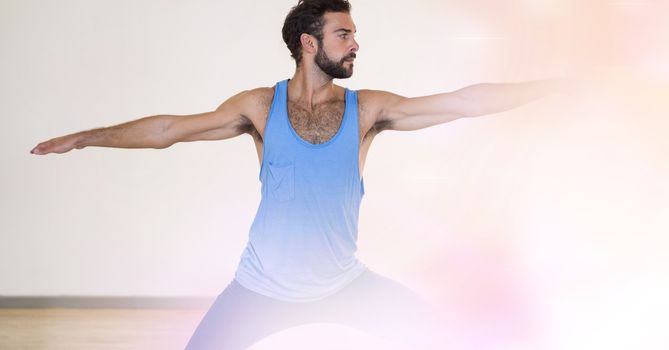 Digital composite of Young man performing yoga in gym