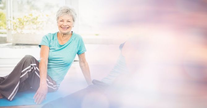 Digital composite of Fit senior woman exercising in yoga class