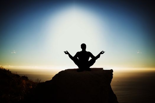 Silhouette businessman practising yoga against scenic view of mountain by sea against sky