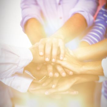 Team of businesspeople forming handstack in office