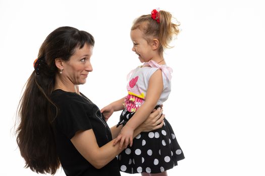 Mom and four-year-old daughter look at each other with fun