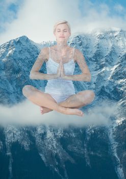 Digital composite of Woman doing yoga in front of snow-covered mountains