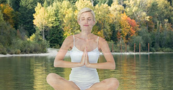 Digital composite of Woman doing yoga in front of a lake and wood