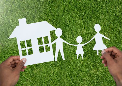 Digital composite of Cut out family and house over grass