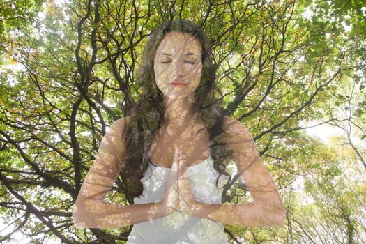 Digital composite of Woman doing yoga under a tree