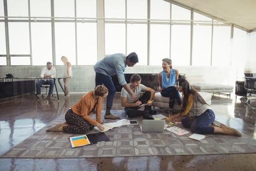 Group of business people discussing in creative office