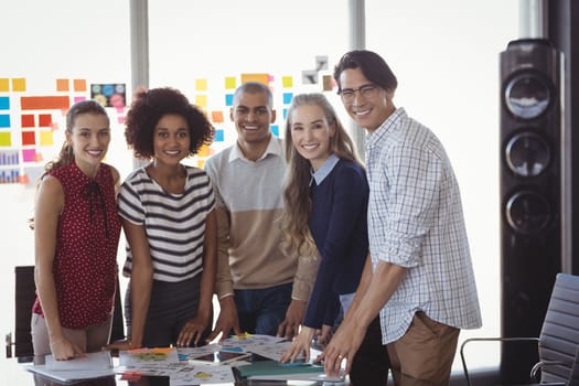 Portrait of business people standing in creative office