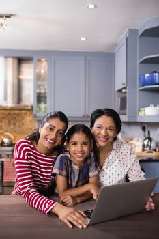 Portrait of happy multi-generation family in kitchen at home
