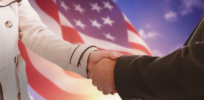 ale and female corporate people shaking hands against composite image of focus on usa flag