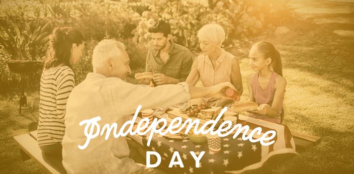 Independence day text against white background against happy family having a picnic