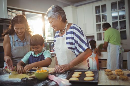 Family preparing dessert in kitchen at home