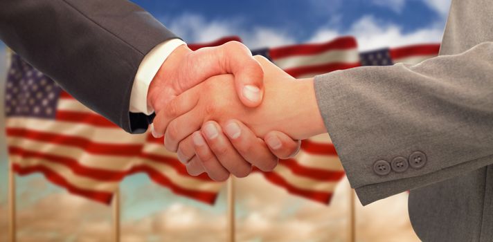 Handshake between two business people against composite image of us flag