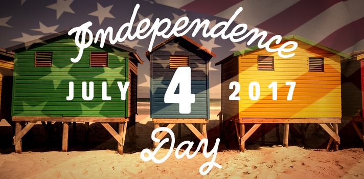 Digitally generated image of happy 4th of july message against colorful huts on sand at beach