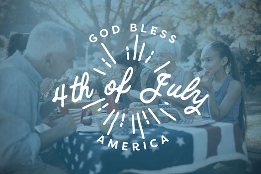 Digitally generated image of happy 4th of july message against happy family having a picnic