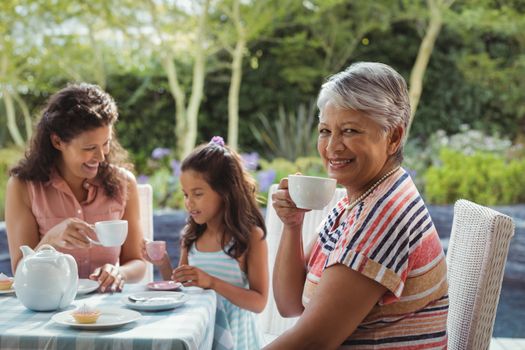 Happy family having tea at home