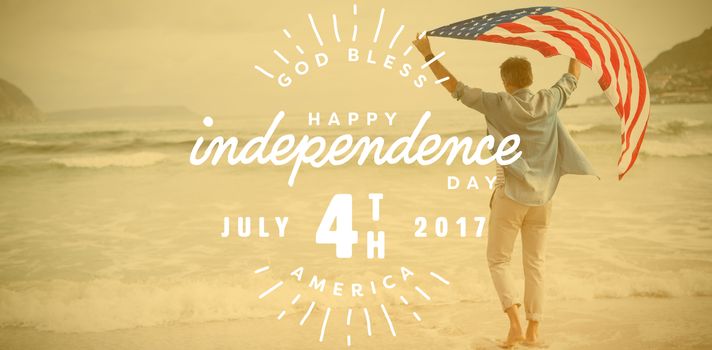 Digitally generated image of happy 4th of july text against man carrying american flag on shore