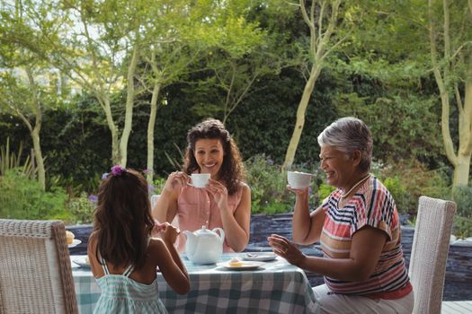 Happy family having tea at home