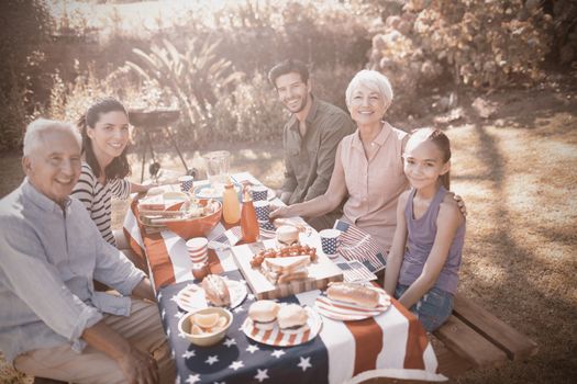 Happy family having a picnic on an american tableclothe