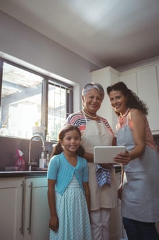 Happy family using digital tablet in kitchen at home