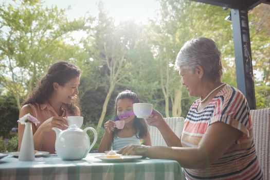 Happy family having tea at home