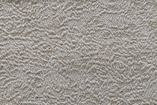 Taupe abstract grungy decorative texture. Textured paper with copy space. Motley gray-brown paper surface, texture closeup.