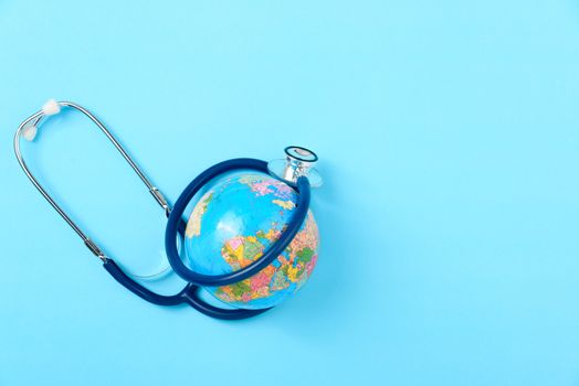 World health day concept, Stethoscope, globe on blue background with copy space. Global health care