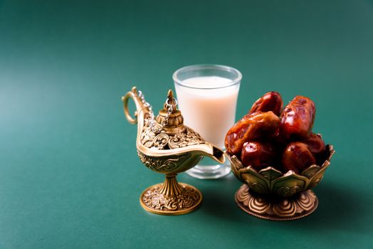 Ramadan, Dates in golden bowl, Milk, arabian Aladdin golden lamp vintage style on black green background
